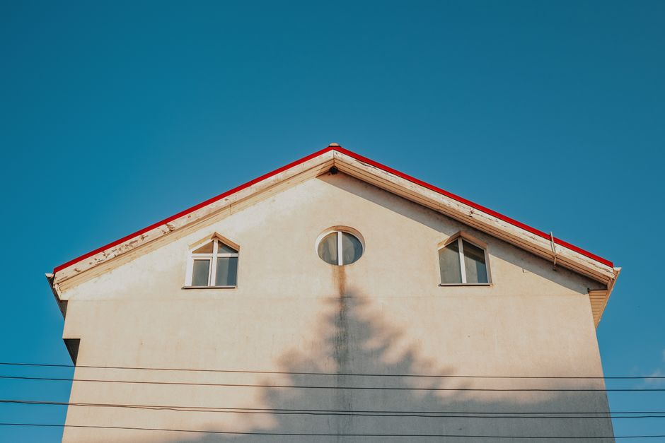 Exterior view showing intersecting residential rooflines and gutters.