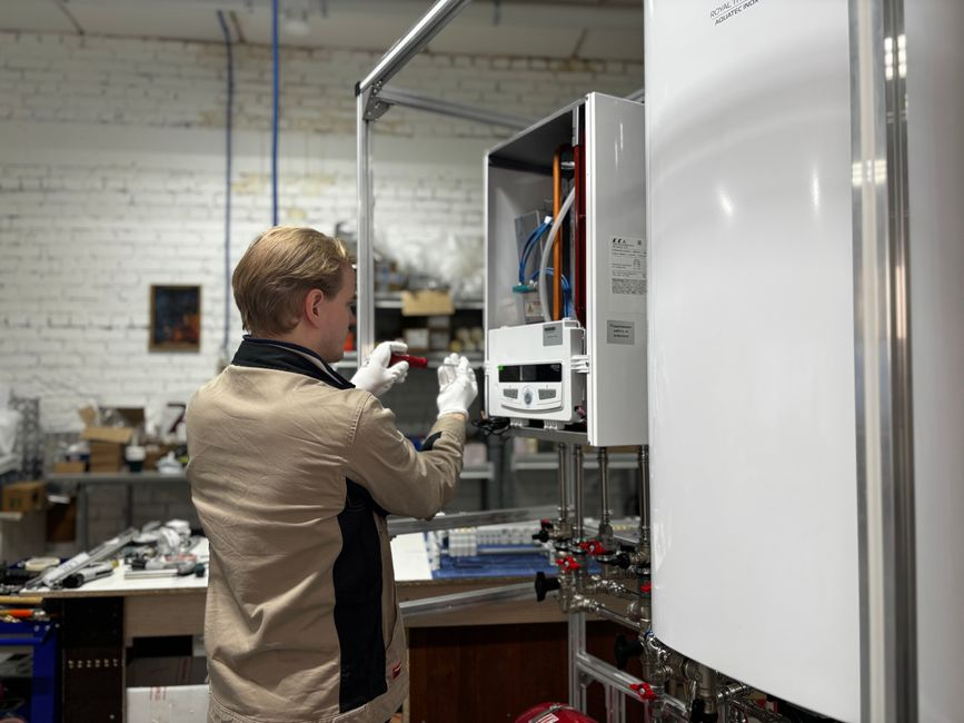 A pest-control professional inspecting likely mouse entry points in a home, including under-sink plumbing and attic access.