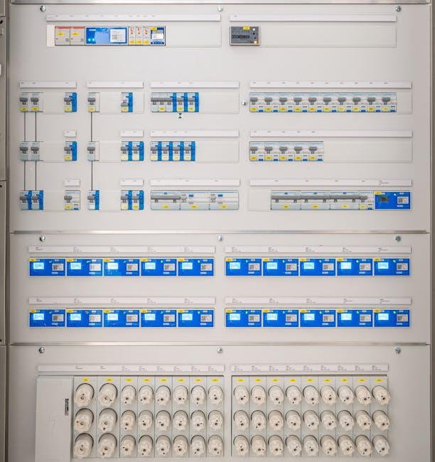Interior of an industrial control room with monitoring equipment and electrical panels.