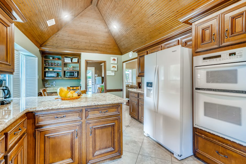 A bright updated kitchen with new cabinets, countertops, and lighting while keeping a familiar layout.