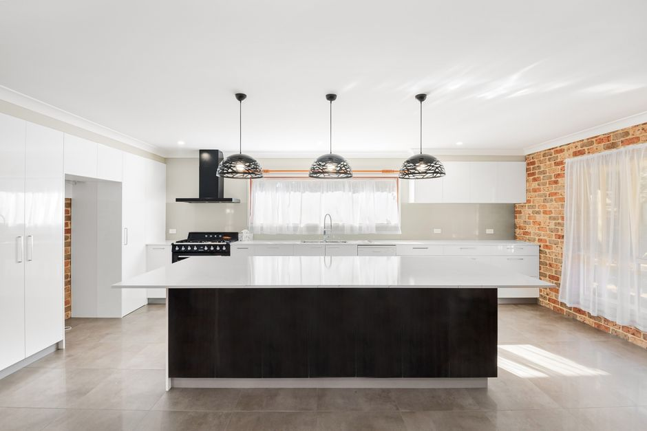 A kitchen renovation featuring an enlarged island and an open connection to the adjacent living area.