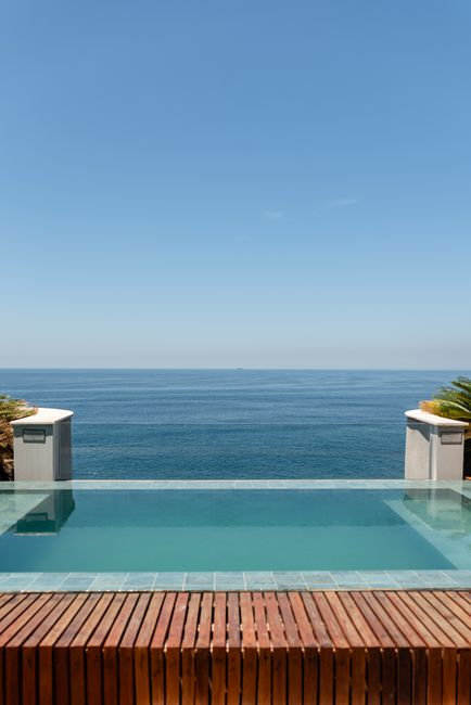 A secluded boutique hotel terrace with a private pool or jacuzzi and open sea views.