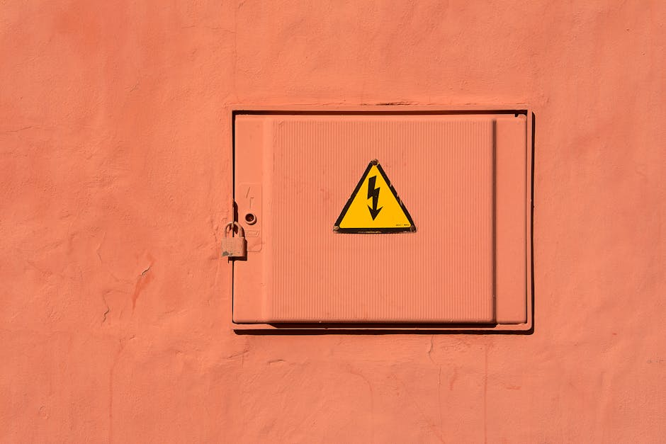 An electrician inspecting a residential electrical panel with labeled breakers.