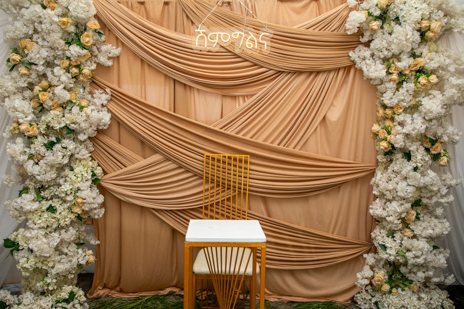 Soft sheer fabric draped across a ceremony space with flowing chiffon panels and gentle natural movement.