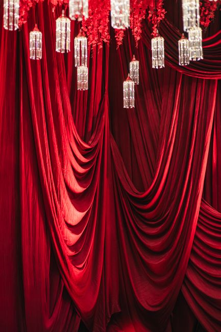 Rich velvet backdrop installed behind an event or stage area, creating deep color and strong light absorption.