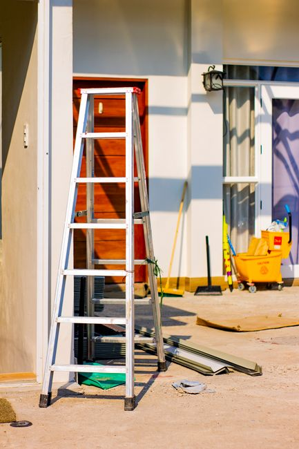 A restoration technician using professional water extraction and drying equipment inside a water-damaged home.