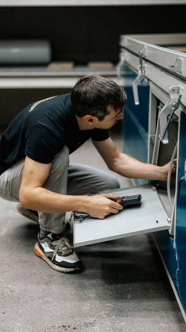Facility technician inspecting equipment or infrastructure inside an industrial electrical or utility setting.