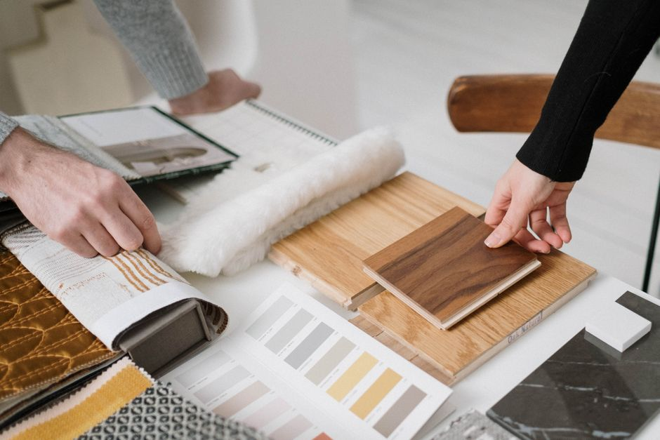 A tabletop display of cabinetry, tile, stone, and finish samples used for home design selections.