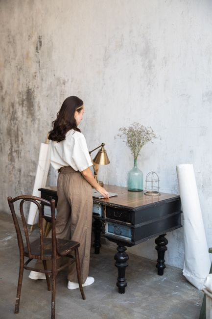 A bright backyard office or studio with a desk, large windows, and a calm interior.