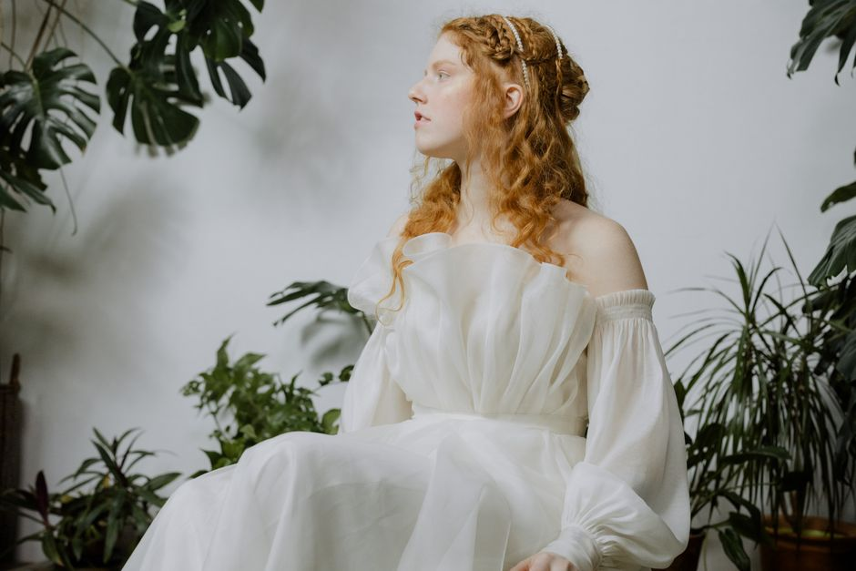 Dress with voluminous sheer puff sleeves that hold their shape away from the body.