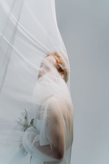 Bride wearing a sheer veil with airy structure and gentle light-catching sheen.