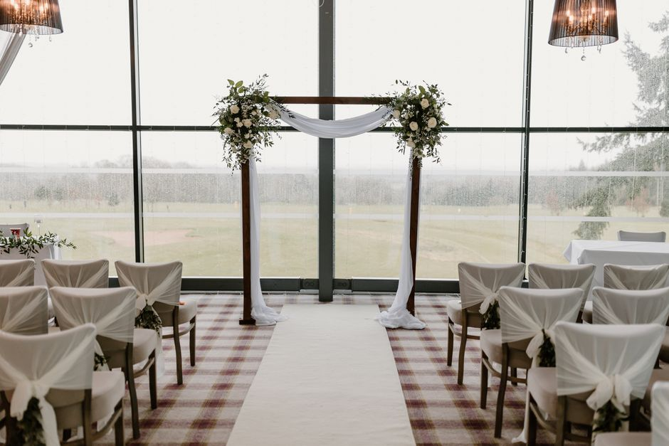 Event space decorated with sheer organza draping and light-catching layered fabric accents.
