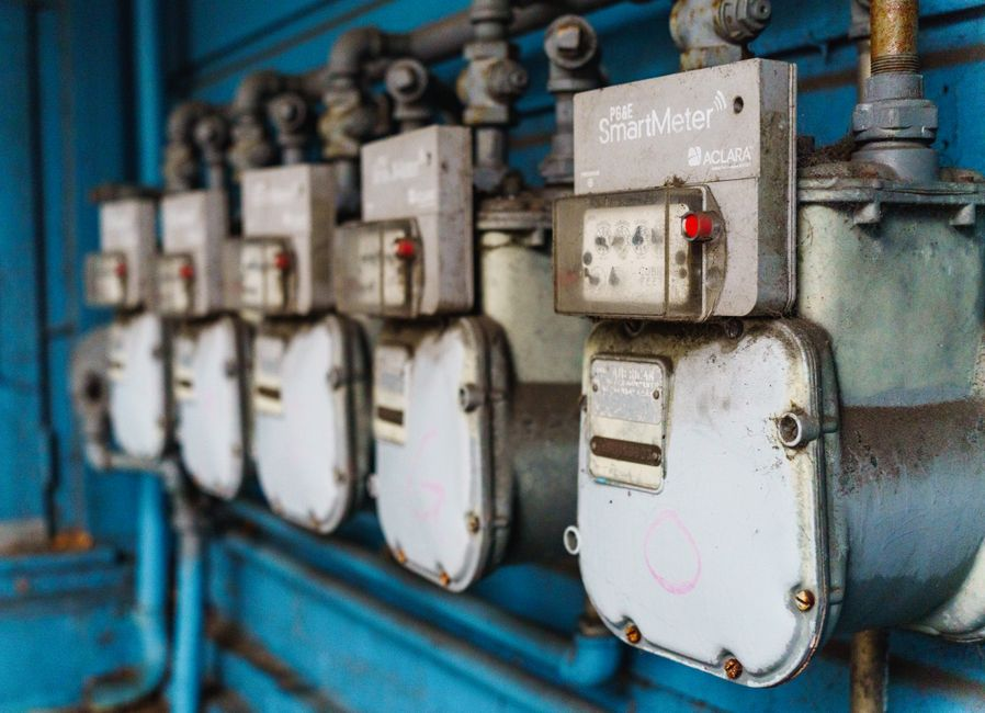 Facility staff member inspecting an industrial access point near utilities or a loading area.