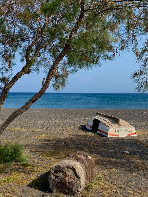 A quieter small beach with calm water and a more understated local atmosphere.