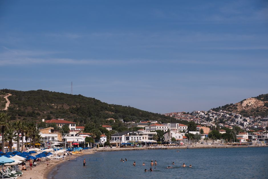 A calm beach near Plomari with clear blue water and a relaxed late-summer atmosphere.