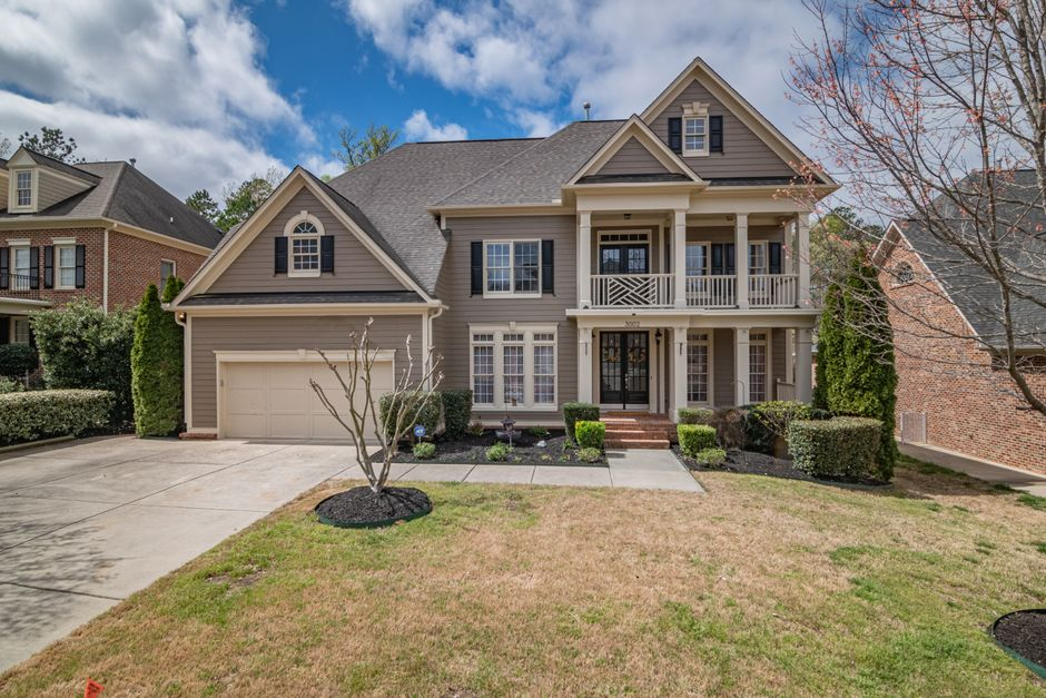 A home garage and side-yard area with stored items, exterior gaps, and sheltered edges where rodents could hide.