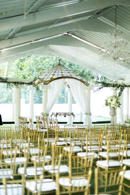 Soft ceiling drapes gathered across an event venue overhead, creating flowing swags above a reception space.